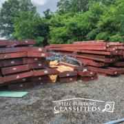 Red Iron Beams Sitting on Gravel